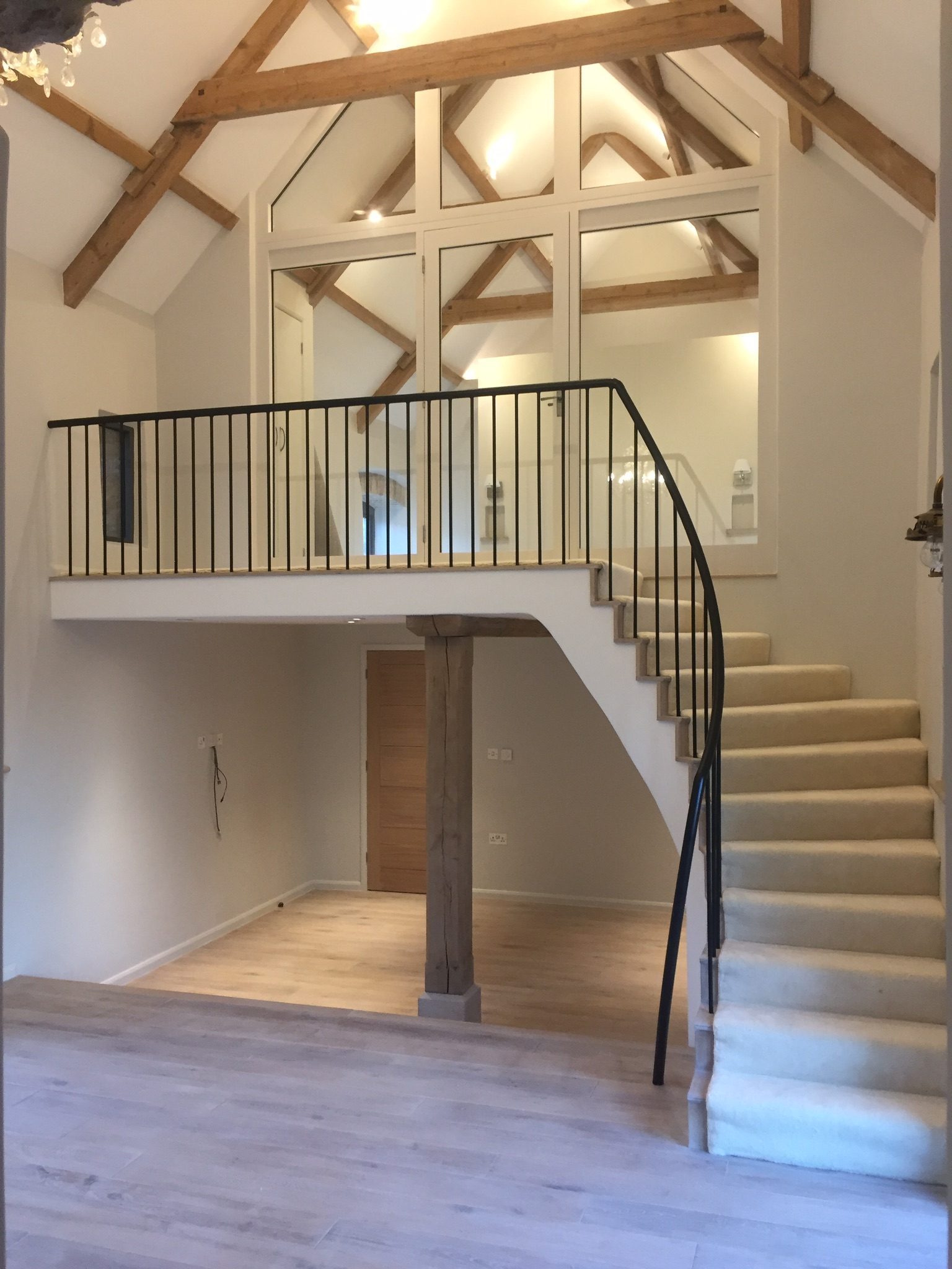 Bespoke curved staircase inside a converted listed barn